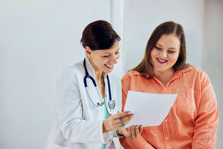 Doctor and patient reviewing documents together, representing collaborative care